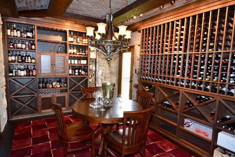 Wood-rack wine cellar with a tasting table and cigar humidor.