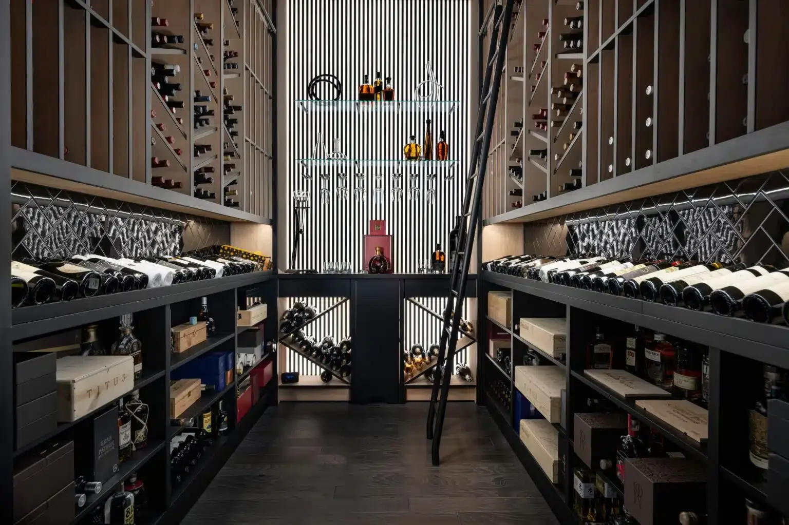 A contemporary wine room with dark cabinetry, tall bottle racks, and display shelves.